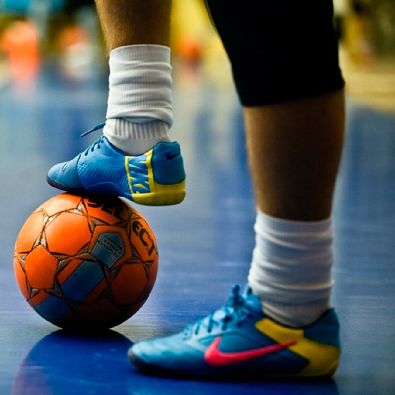 Close-up of a player resting a foot on a futsal ball